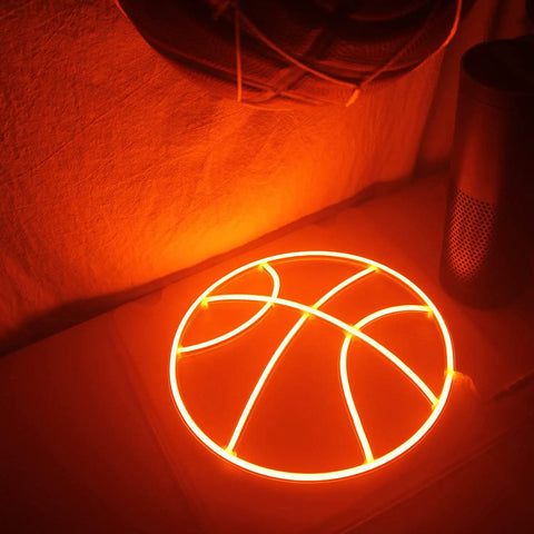 Basketball Neon Sign LED Light 11.8 Inch for Bedroom Decor and Game Room Aesthetic glowing on table, warm orange hue