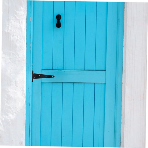 Gate hinge on blue wooden gate; black metal slotted heavy-duty outdoor hardware