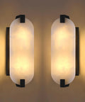 Tonabona 2 Pack 2 Light 15" Natural Alabaster Oval Marble Farmhouse Bathroom Black Wall Sconce with warm lighting.