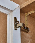 Heavy Duty L Bracket Corner Brace With Screws Rock Solid Right Angle Shelf Support For Furniture Repair And Woodworking No Sweat Assembly 8 Pack installed on cabinet corner.