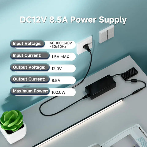 Universal 100-240V AC to 12V DC Power Supply Adapter 102W 8.5A ETL Listed on desk with connected LED strip light