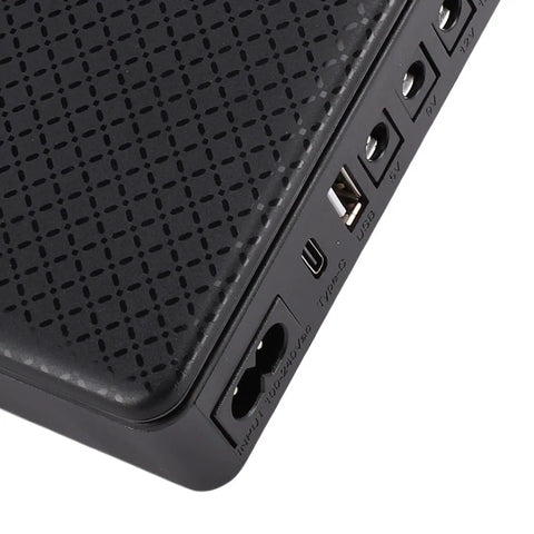 Lightweight Mini UPS Backup Power Supply For Routers And Modems 20800Mah Battery showing input and output ports.