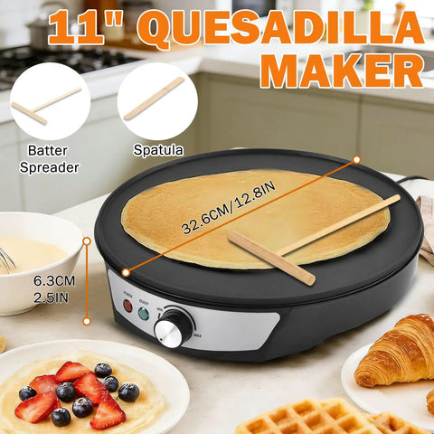 11-inch quesadilla maker with crepe batter spreader and spatula on a kitchen counter with pancakes and waffles