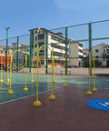 Drone Racing Obstacle Course Kit For Indoor And Outdoor Flying set up on basketball court with yellow hoops and landing pad
