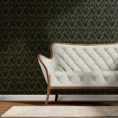 Kickstart Your Vibe With This Fresh Indigo Floral Folk Wallpaper Featuring A Slick Gold Metallic Coating Premium Paste The Wall Covering Eco Certified Type I Rated applied in a living room with a white tufted couch.