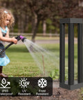 Child watering garden near Outdoor Solar Floor Lanterns Set Of 2, Stainless Steel Black Lantern Lights, weatherproof symbols visible.