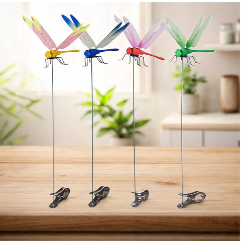 Multicolor 12-Pack dragonfly clips on table, showing colorful designs on metal stakes for garden decor; Dope Dragonfly Clip 12 Pack For Garden Decor And Outdoor Stakes DIY Fake Dragonfly Clips For Hair Accessories, Pets, Patio Enhancement, And Plant Stems Multicolor 3D Dragonfly Charms