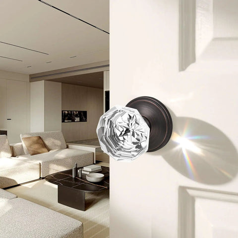 Crystal Glass Door Knob Set 2 Pack In Oil Rubbed Bronze Finish Slick Passage Style Zinc Alloy Rosettes Adjustable Latch For Interior Doors Up To One And Three Quarters Inches Thick Smooth Operation Durable Hardware with clear crystal knob installed on a white interior door showing light reflection in modern living room