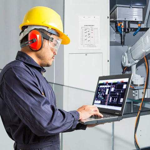 Worker using a laptop for inspections with Equipment Inspection Cards Pack 20 Sets With Waterproof PVC Sleeve Safety Tags visible on cabinet.