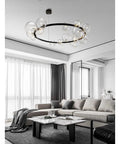 Fresh Modern Metal Chandelier with 39 Clear Glass Bubbles and G9 Sockets Creates a Killer Vibe for Living Rooms, Bedrooms and Kitchens Sleek Pendant Light with Soft Glow and Easy Clean Finish hanging in a stylish living room.