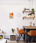 Room with wall displaying Vintage Ramen Wave Metal Tin Sign Wall Art 8x12 Inch above a modern white and wood-themed kitchen setup.