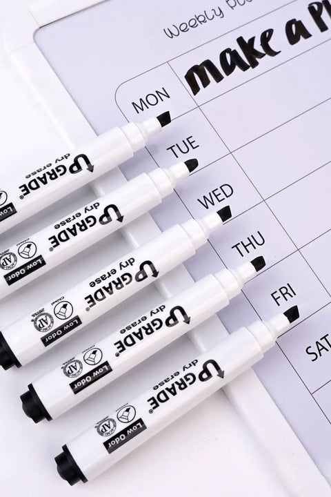 Black Dry Erase Markers 12 Count Set with low odor ink and chisel tip shown with weekly planner on whiteboard surface