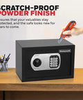 Scratch-proof black compact home safe with digital and key lock, DOJ-approved, 0.28 cu ft, on desk with cutter demonstrating durability.