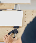 Person using Clamping Elements 2 Pack for Precise Workpiece Fixing in Woodworking on a workbench with a wooden board.