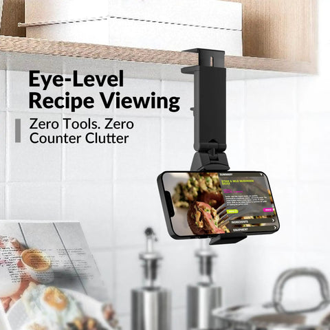 Universal In Flight Phone Holder Mount For Airplane Hands Free Viewing with a recipe open, attached under a kitchen cabinet.