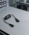 Straight Up Reliable EV Charger Detector And Voltage Current Tester For Electric Vehicles KWS DC22 on a work surface, showing plug connections.