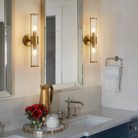 Gold Aluminum Wall Sconce With Cut Glass Shade, Up And Down Lighting in bathroom setting above mirror