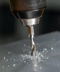No Nonsense Combination Drill Tap And Countersink Bit For Up To 10 Gauge Metal in use, drilling into metal with shavings visible.