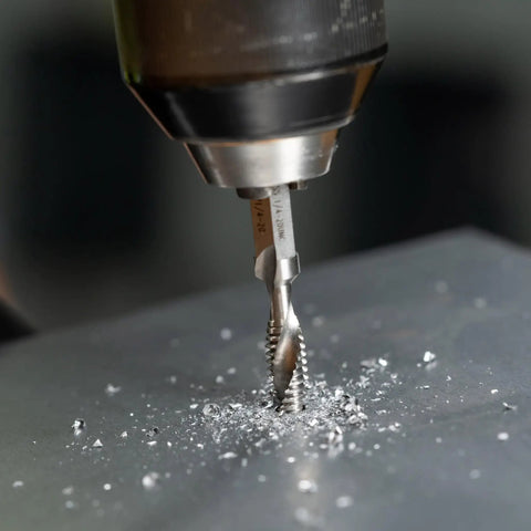 No Nonsense Combination Drill Tap And Countersink Bit For Up To 10 Gauge Metal in use, drilling into metal with shavings visible.