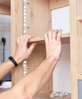Setting up Heavy Duty Steel Shelf Clips for Metal Cabinets, showcasing easy support installation in bookcases and file cabinets.