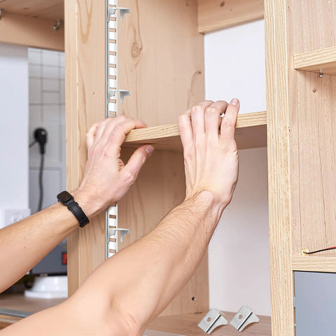 Setting up Heavy Duty Steel Shelf Clips for Metal Cabinets, showcasing easy support installation in bookcases and file cabinets.