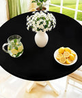 Round Spandex Tablecloth With Elastic Edge No Slip Waterproof Stretch Fit For 45 To 56 Inch Tables Ideal For Indoor Outdoor Dining And Camping Picnics Easy Care Washable Black on a table with vase and lemons