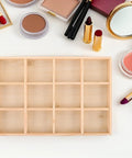 Knockout Solid Wood Jewelry Tray With 12 Grid Compartments, smooth finish, displayed alongside makeup essentials.