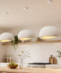 Bennyes Wabi Sabi Pendant Light 19.7 in White Modern Pendant Lights in kitchen with white cement shade and warm LED bulb.