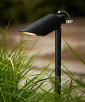 Low Voltage Landscape Spotlight Kit 4 Pack 12V 5W Tri Color 2700K 3000K 4000K 23.6 Inch Tall Adjustable Tree Uplights IP65 Aluminum Outdoor Black ETL Listed in garden setting, adjustable angle shown