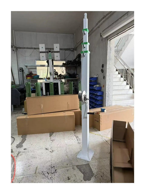 30 Foot Telescoping Lift Mast With Smooth Crank Handle Winch Rock Solid Stainless Steel Light Tower Pole and Antenna Support System in workshop.
