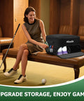 Woman sitting next to a Golf Trunk Organizer With Shoe Storage And Ventilated Compartment Waterproof Car Trunk Locker For Golf Gear And Accessories 2 Pair Capacity Ideal Gift For Men Black, displayed on a bench with golf shoes visible inside.