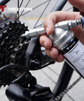 Mini Grease Gun For Tight Spots One Handed Push Type With Needle Nozzle 3oz Capacity in use on bicycle gear