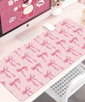 Large Pink Bow Desk Mat For Women 31.5 Inch Non Slip Keyboard And Mouse Pad With Stitched Edge on a desk with computer and accessories