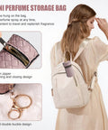 Woman with backpack holding Super Portable Mini Refillable Perfume Atomizer Bottles Set - 5 Pack Of Travel Size 5ml Spray Options, close-up.