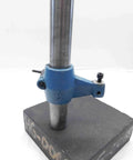 Granite Indicator Base And Comparator Stand With A Six By Six By Two Inch Platform And A Seven And A Half Inch Tall Rod For Pro Grade Machinist Metrology In Your Heavy Duty Machine Shop, blue metal clamp on granite base