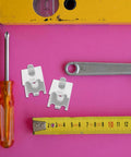 Two stainless steel refrigerator shelf clips for efficient space utilization and quick install with tools on pink background.