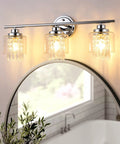 Lit Three Light Crystal Vanity Light Fixture For Bathroom Hallway And Bedroom with clear glass shades above a mirror