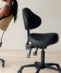 Pneumatic Swivel Saddle Chair With Wheels For Hair Stylists Dentists Hygienists And Spa Pros Ergonomic Back Support All Day Comfort Posture Boost Perfect For Clinic Salon Massage Home Or Office Durable Aluminum Frame In Black side view showing ergonomic backrest and seat.
