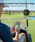 Person using StormBox Micro 3 Portable Bluetooth Speaker With IP68 Waterproofing on golf cart, app control visible