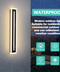 23.6 Inch Outdoor Wall Sconce With 18W LED IP65 Weatherproof Exterior Light Fixture In White Acrylic Modern Wall Lighting For Porch Patio Garage Gates Driveway And Entryways Built For No Fuss Outdoor Living glowing in rain on a wall