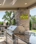 Funny Caution Sign This Equipment Is Supplied By More Than One Power Source on wall of outdoor kitchen area.