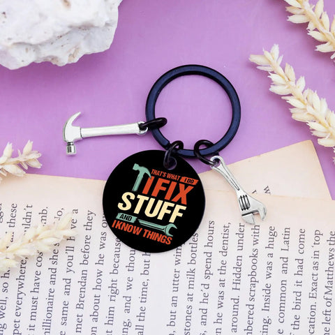 Keychain Gift For Men I Fix Stuff And I Know Things Ideal Dad Gift For Mechanic Handyman Construction Worker Engineer Husband Grandfather Birthday Or Fathers Day Gift For Any Proud Dad Who Fixes Stuff And Keeps Projects Rolling, black metal keychain with wrench and hammer charms on open book