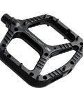 Wave Pedals Black With Convex Front And Concave Back, shown in black with sealed chromoly axle and bushings, top view.