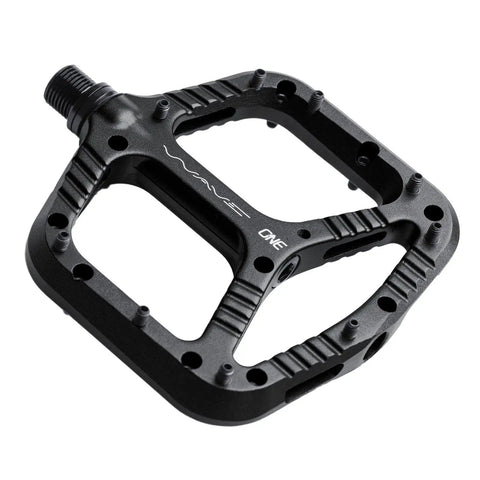 Wave Pedals Black With Convex Front And Concave Back, shown in black with sealed chromoly axle and bushings, top view.