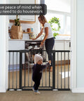 Mother in kitchen with Extra Wide Baby Gate For Stairs And Doorways Fits 29.93 To 51.5 Inches 30 Inches High Auto Close Walk Through Safety Gate For Kids And Pets