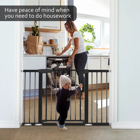 Mother in kitchen with Extra Wide Baby Gate For Stairs And Doorways Fits 29.93 To 51.5 Inches 30 Inches High Auto Close Walk Through Safety Gate For Kids And Pets