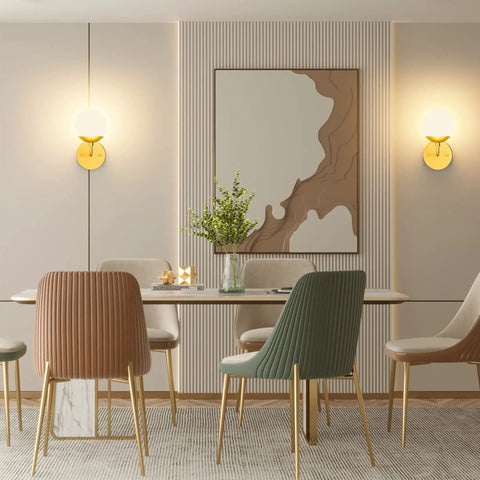 Dining room with Gold Globe Wall Sconce 1 Light Modern Mid Century Dope Gold Wall Light, art piece, and mid-century chairs.