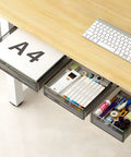 Premium Under Desk Drawer Storage Set With Three Attachable Slide Out Trays For Office And Home Keep The Desktop Hella Tidy. A4 paper and office supplies in clear drawers under a wooden desk.