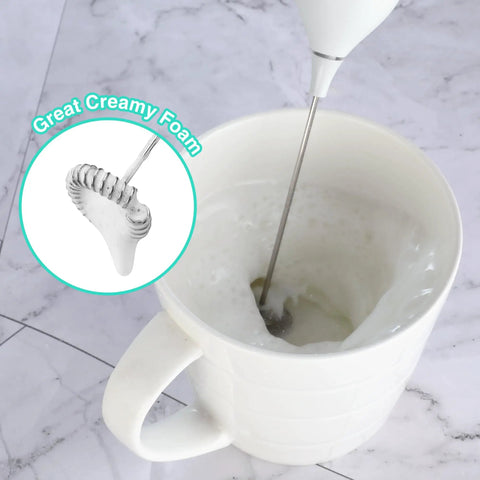 Top Shelf Handheld Rechargeable Milk Frother Wand And Electric Coffee Mixer whips up lush silky foam in white mug.