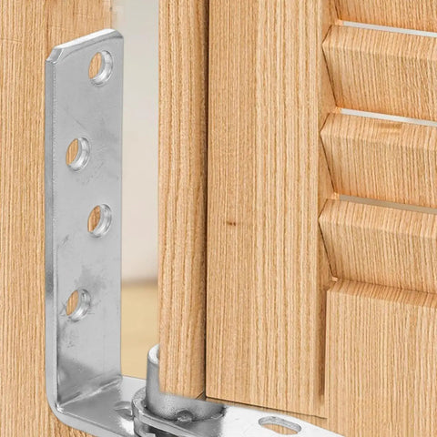 Close-up of stainless steel spring loaded door hinges with automatic rebound for cabinets and doors installed on wood frame.
